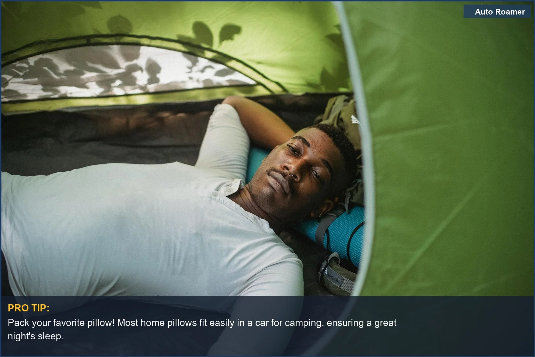 Man relaxing in a tent, demonstrating using a home pillow for car camping comfort.