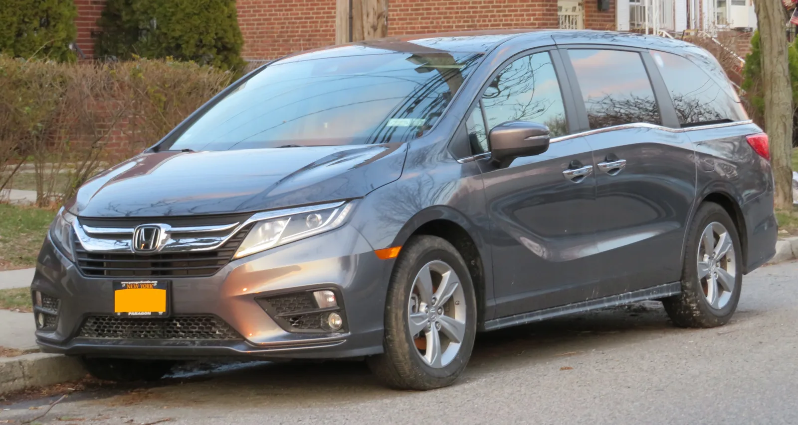 A gray Honda Odyssey minivan, the van whose cargo dimensions for sleeping this guide turns into a flat bed