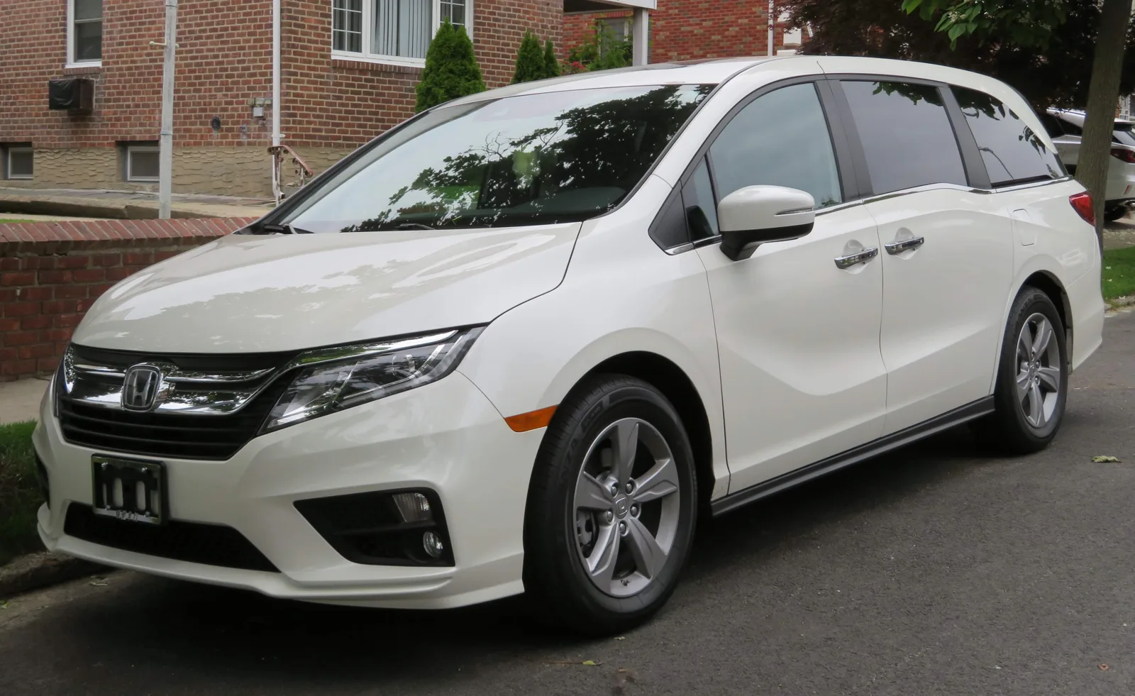 A white Honda Odyssey minivan parked on a street, the vehicle whose sleeping cargo dimensions this guide measures