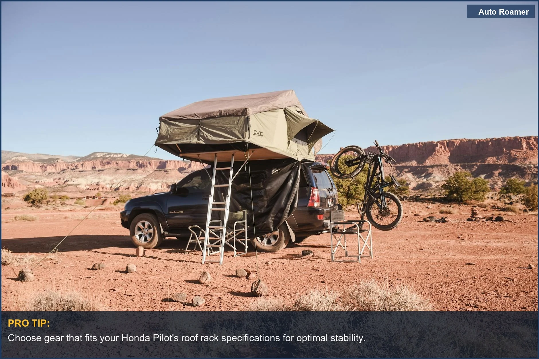 Honda Pilot with rooftop tent and mountain bike in desert camping setup.