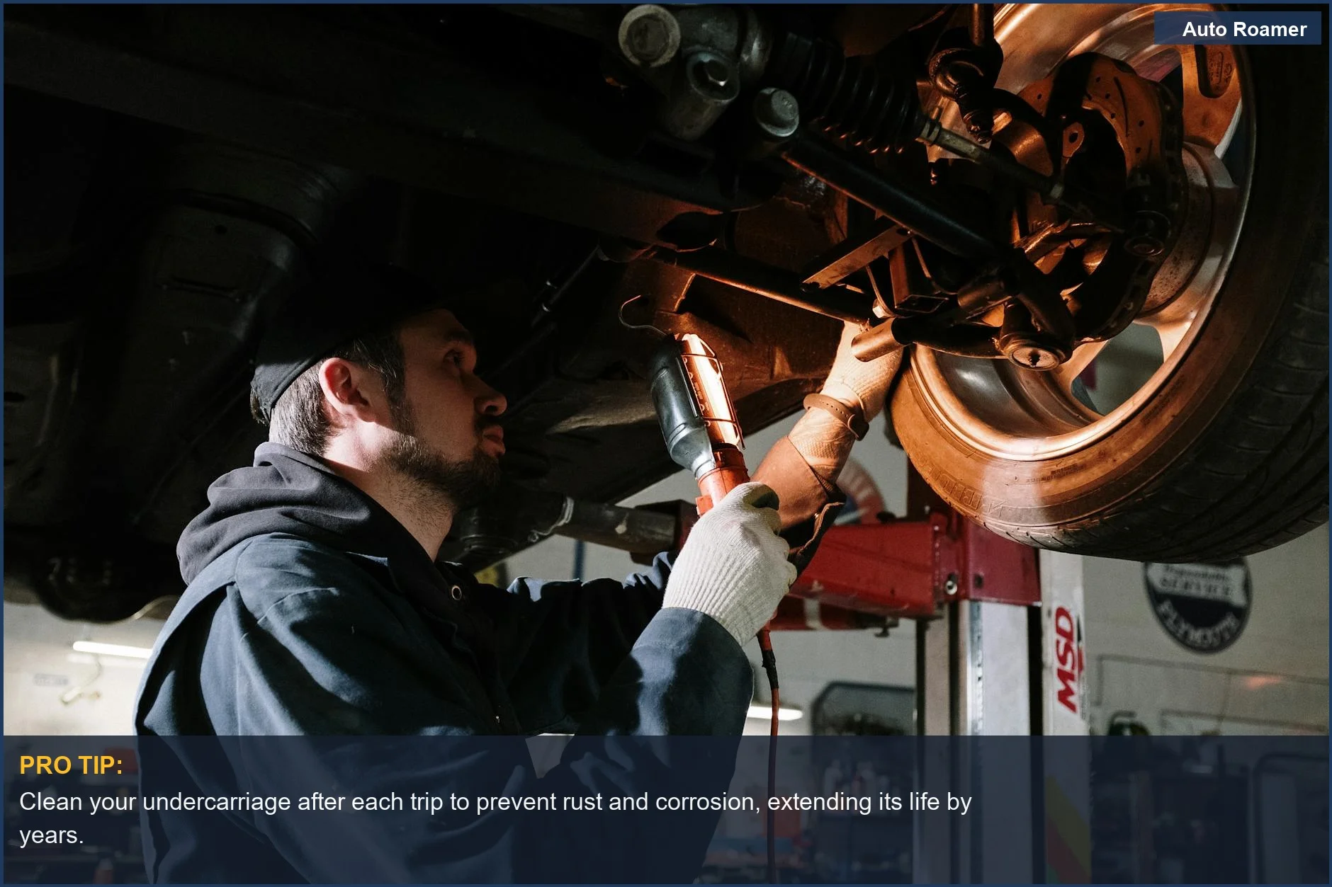 Mechanic inspecting a car's undercarriage, relevant to understanding how car camping impacts vehicle depreciation.