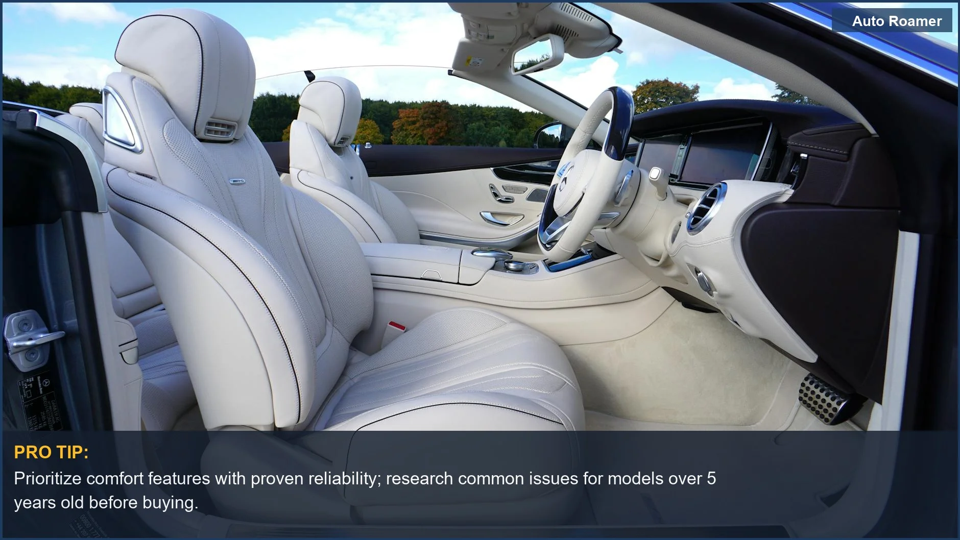 Interior de un descapotable Mercedes de lujo con asientos de cuero crema y tecnología avanzada, que influye en el valor de reventa de las características de confort del coche.