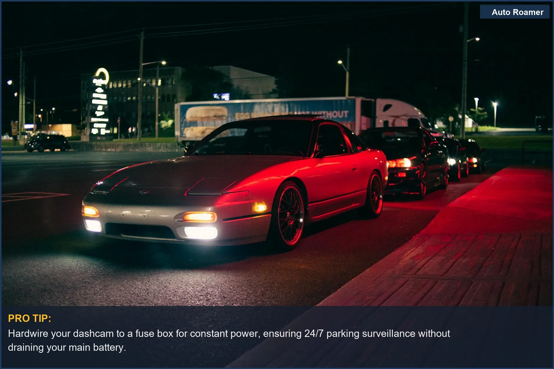 Understand parking mode dashcam installation for stylish cars parked on a city street, illuminated by vibrant headlights at night.