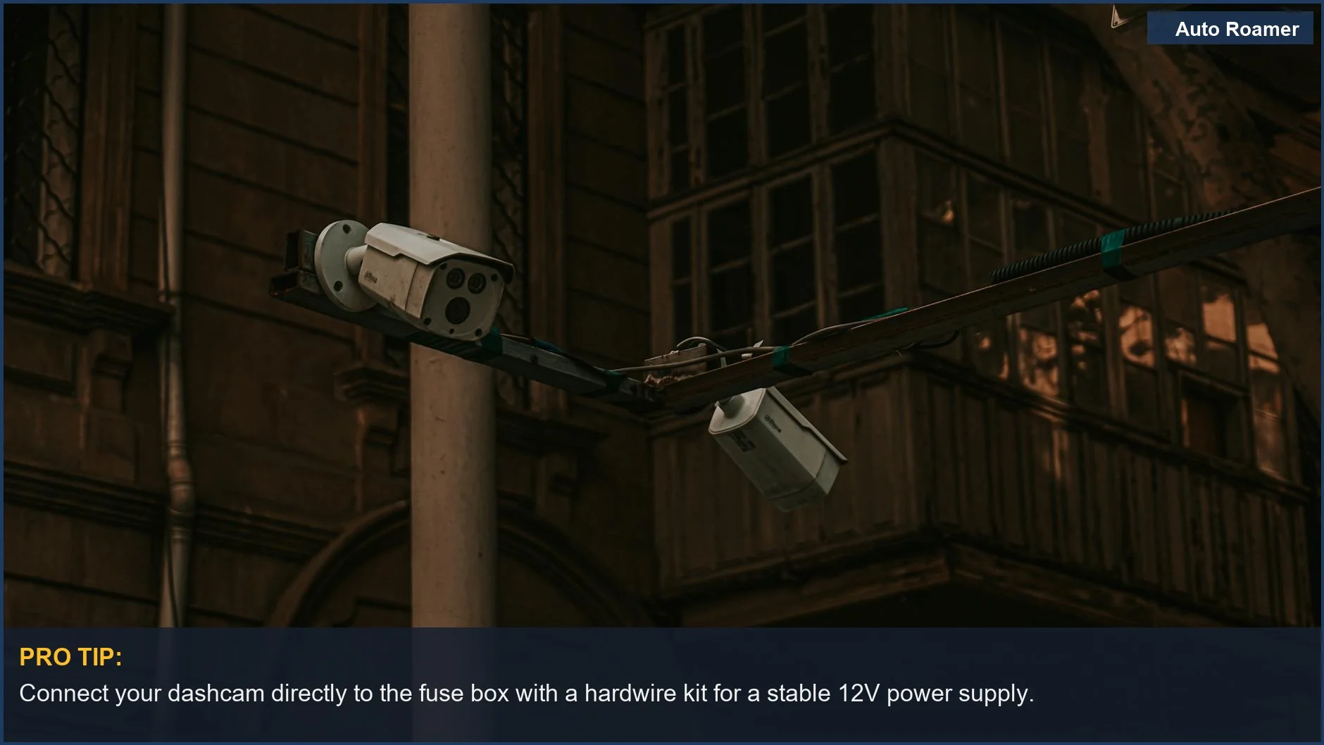 Street surveillance cameras on a pole in an urban setting, demonstrating dashcam parking mode protection.