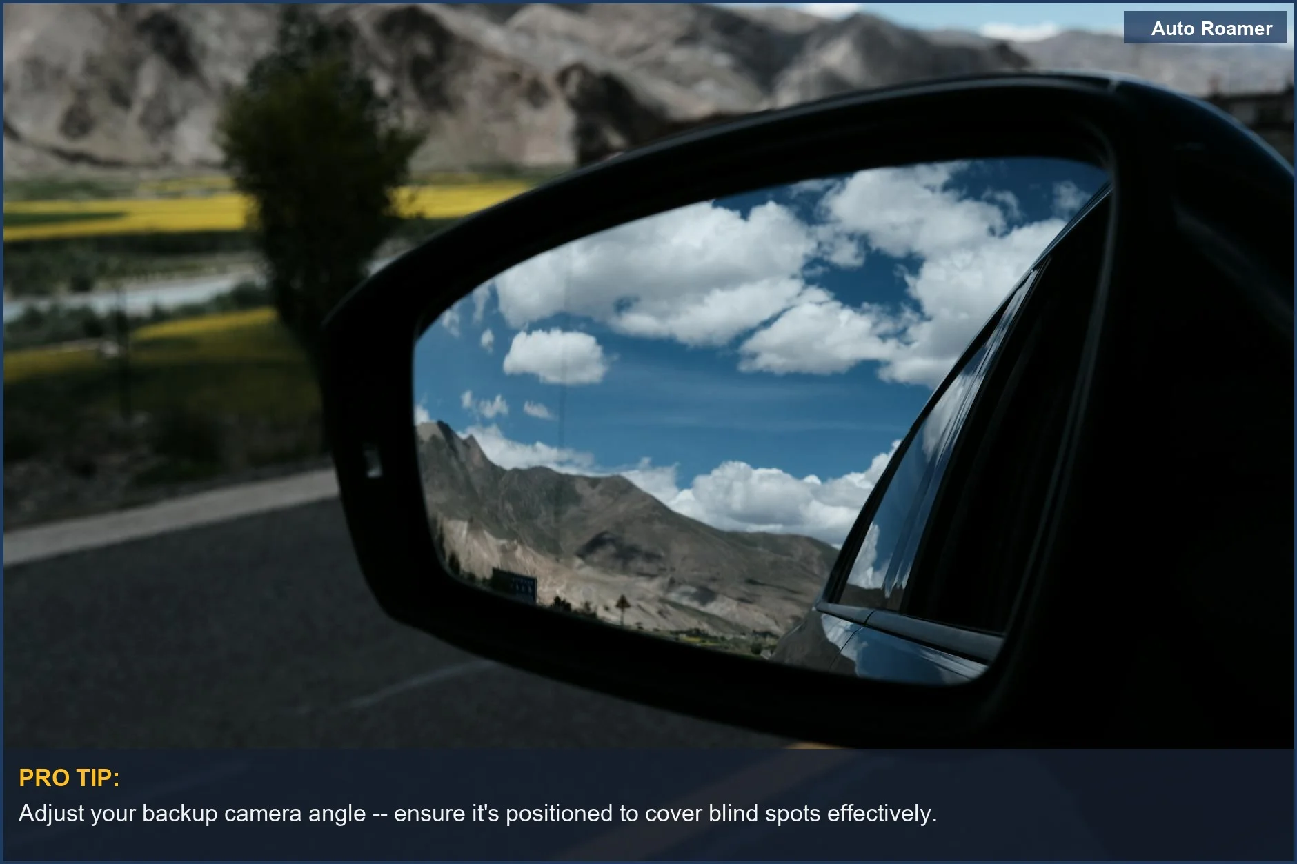 Car mirror reflecting mountains and sky, showcasing the scenic view while reversing with a backup camera.