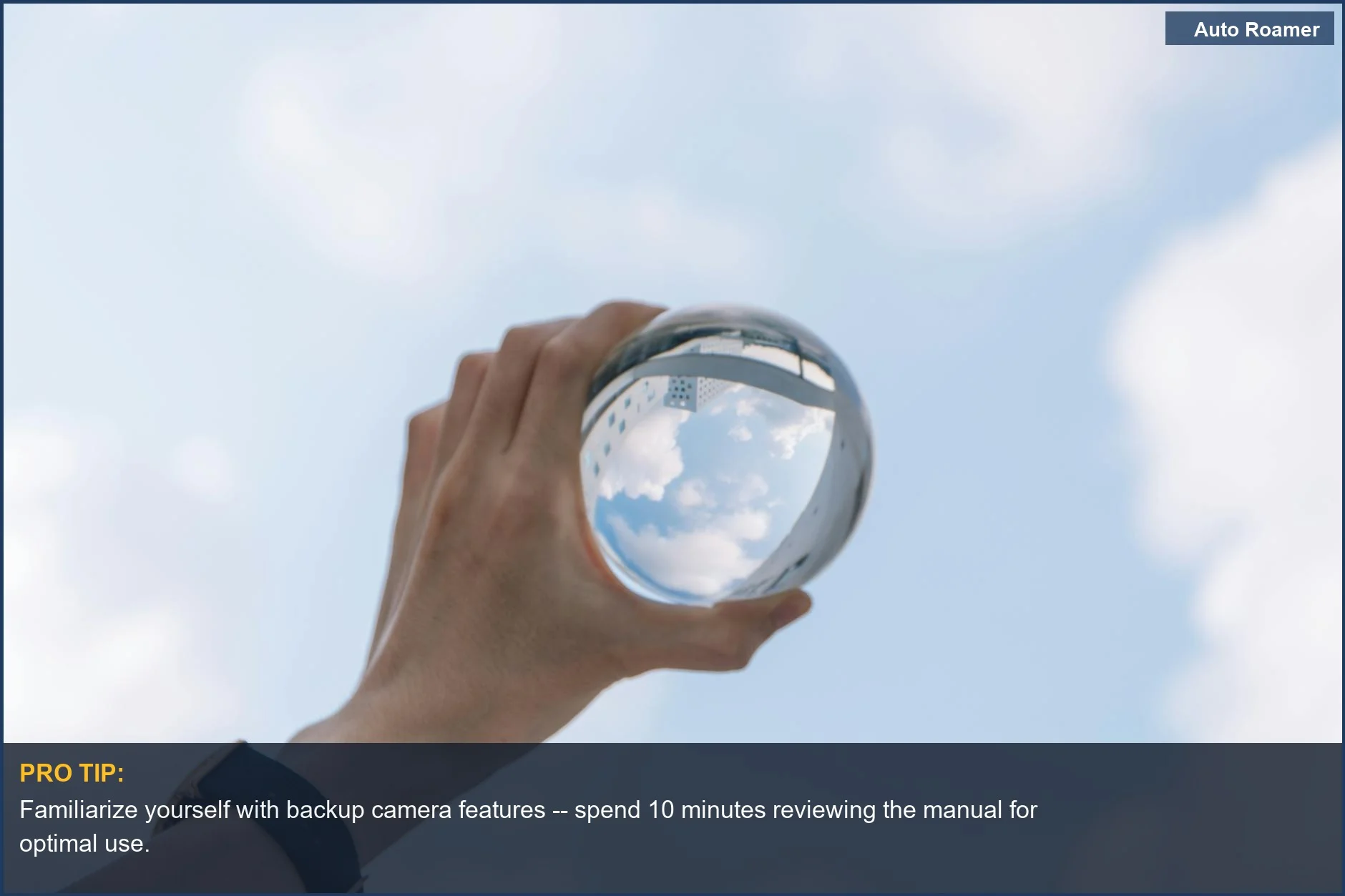 A hand holding a crystal ball reflecting the sky, symbolizing the clarity of backup camera technology.