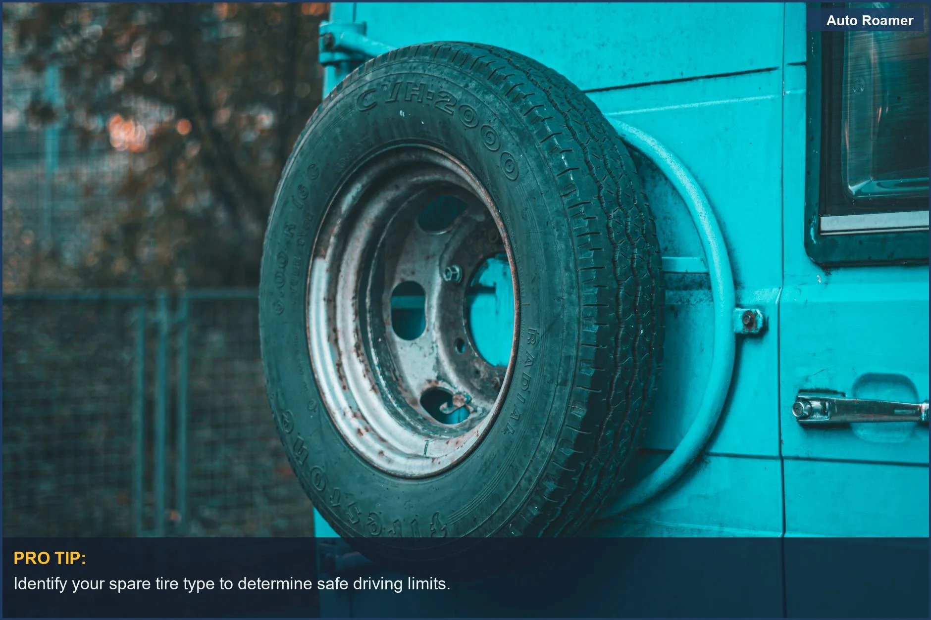 Close-up of mounted spare tire on teal vehicle, emphasizing the importance of tire type in driving distance.