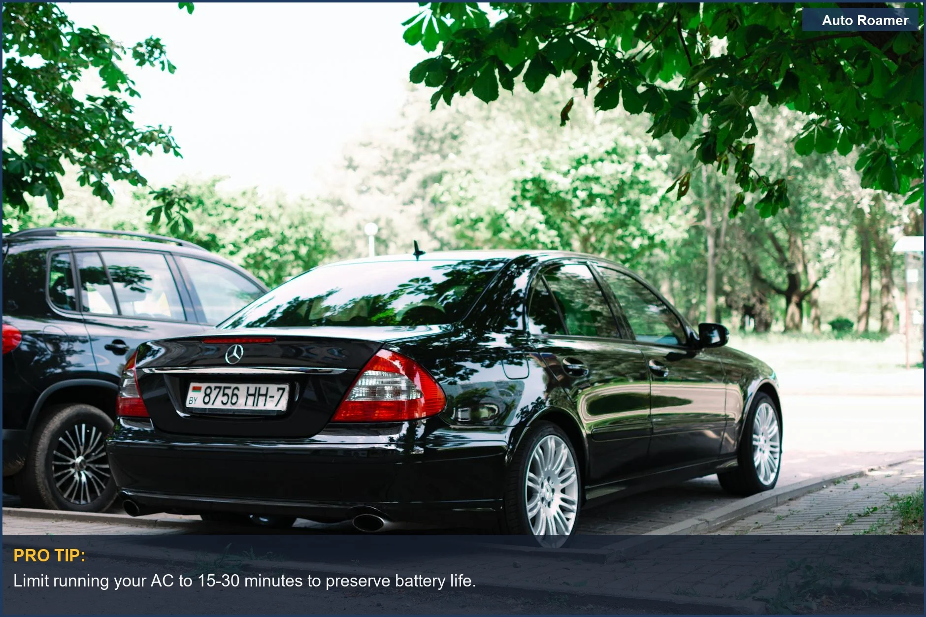 Sleek black car parked under trees, illustrating how long to run car AC while parked.