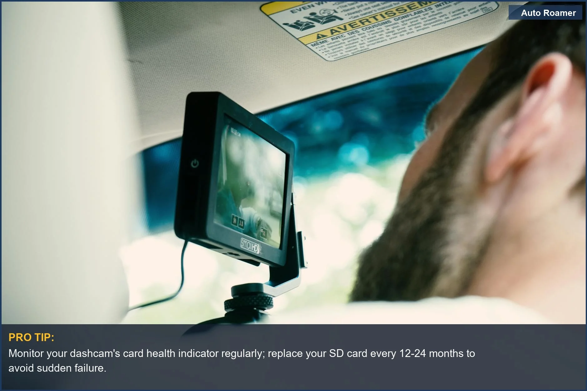 Man using a modern dashboard camera, emphasizing the technology and screen for dashcam card failure prevention.