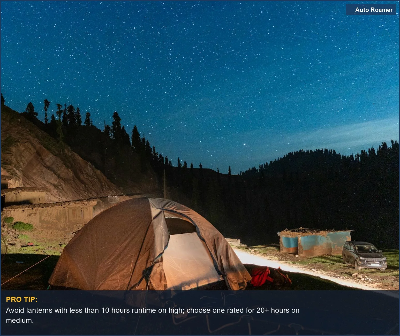 Mountain camping under starry sky with lit tent, demonstrating the importance of rechargeable lantern duration.