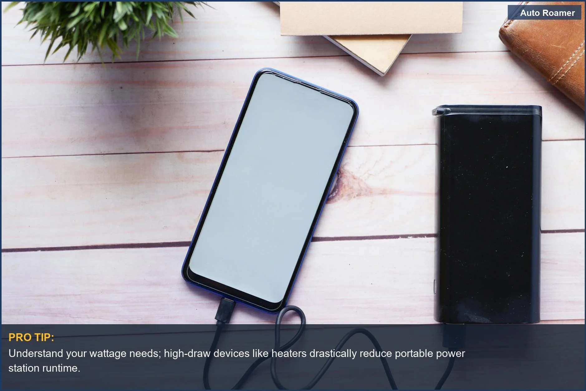 Portable power station charging a smartphone on a wooden desk, demonstrating essential tech for solar generator battery life.