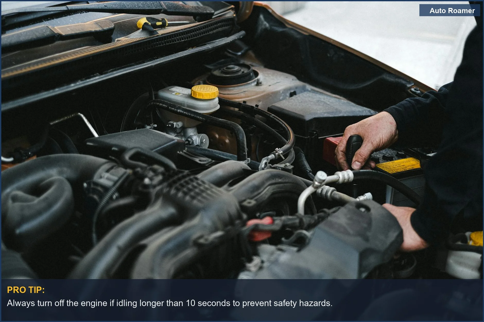Mechanic's hands working on a car engine, focusing on safety risks associated with idling.