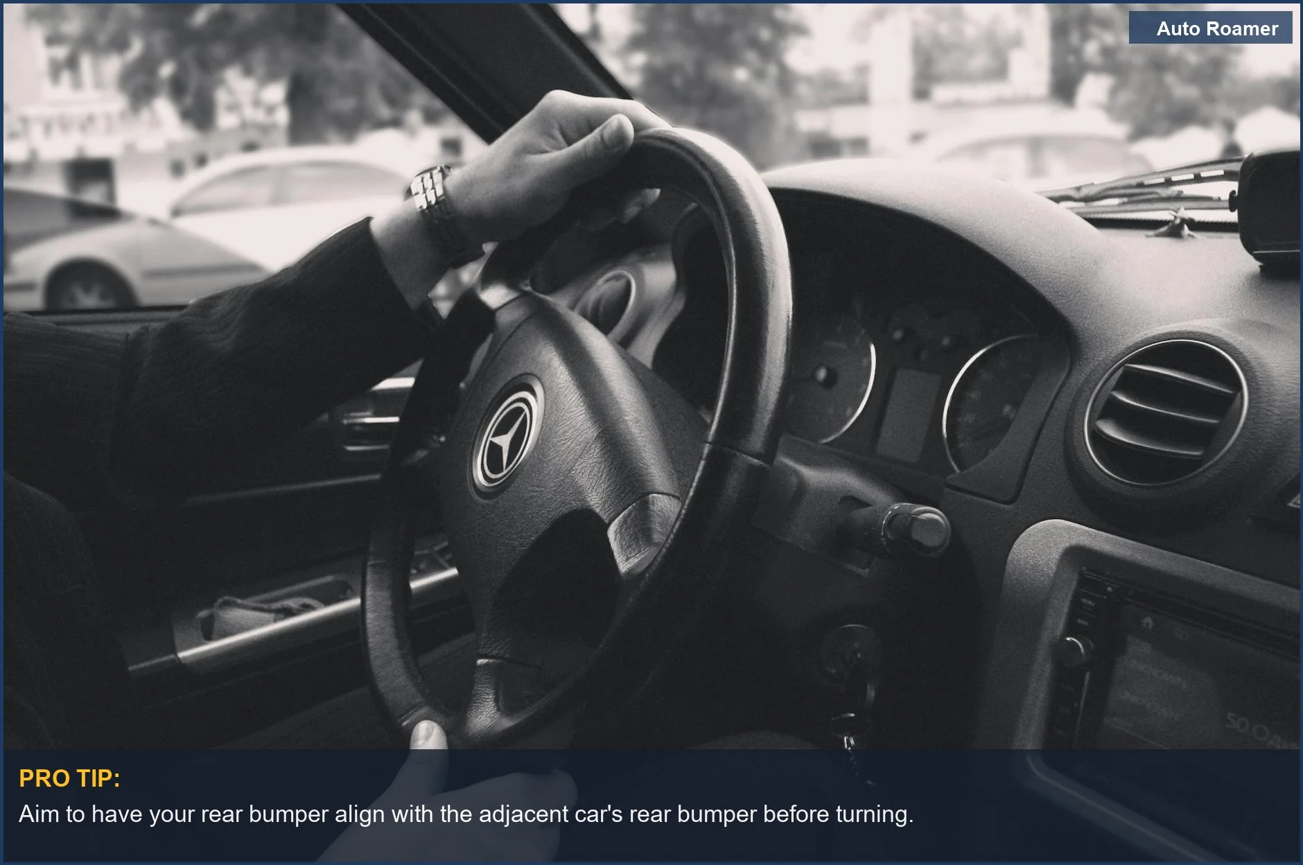 Luxury car interior, black and white photo of the steering wheel and driver's hands, illustrating the reverse park technique.