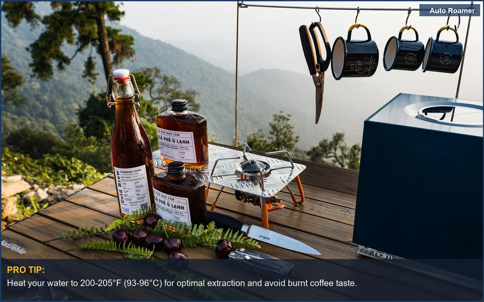 Close-up of outdoor coffee brewing tools and accessories on a wooden surface.