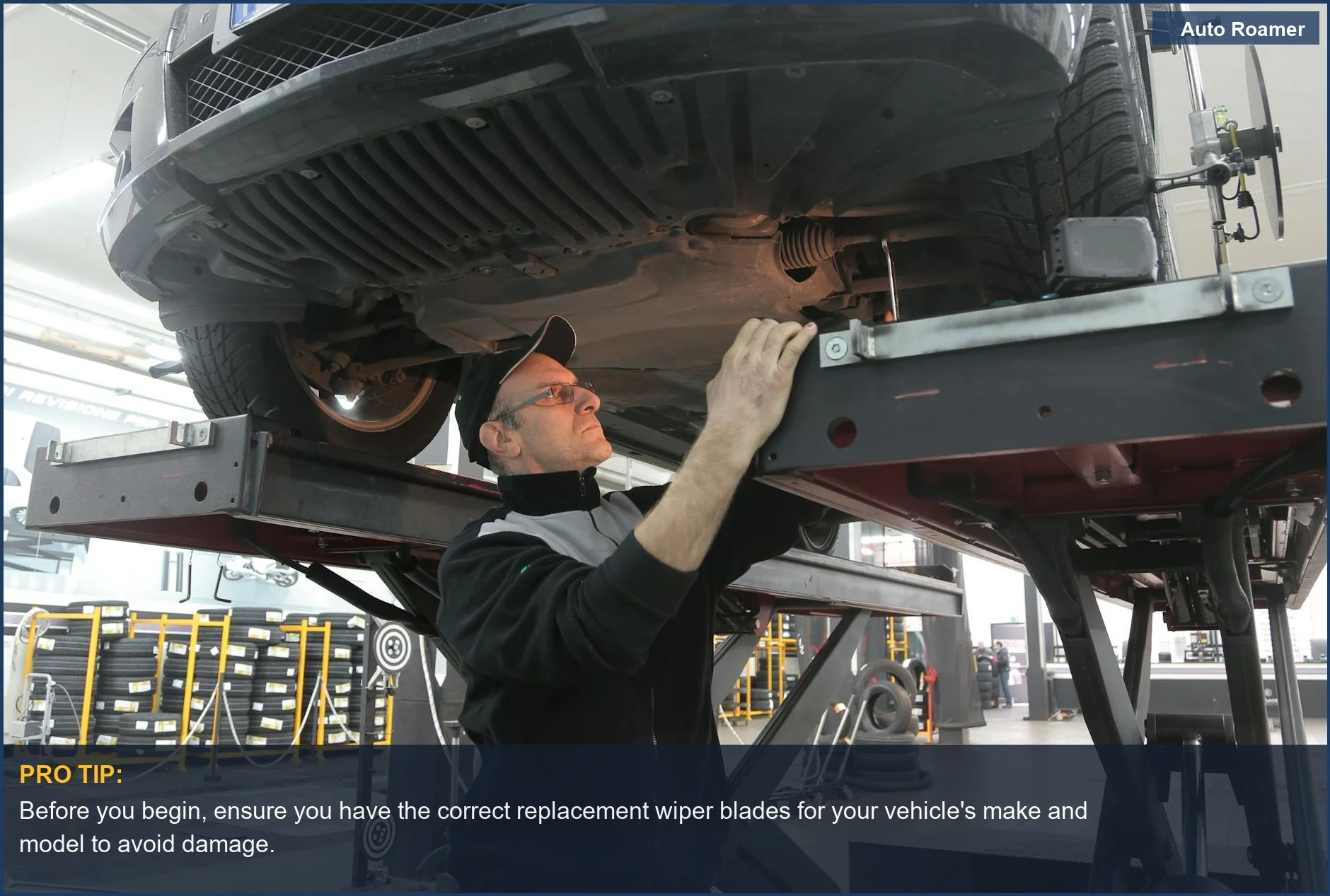 Close-up of a mechanic's hands replacing a car's windshield wiper blade, demonstrating DIY wiper replacement.
