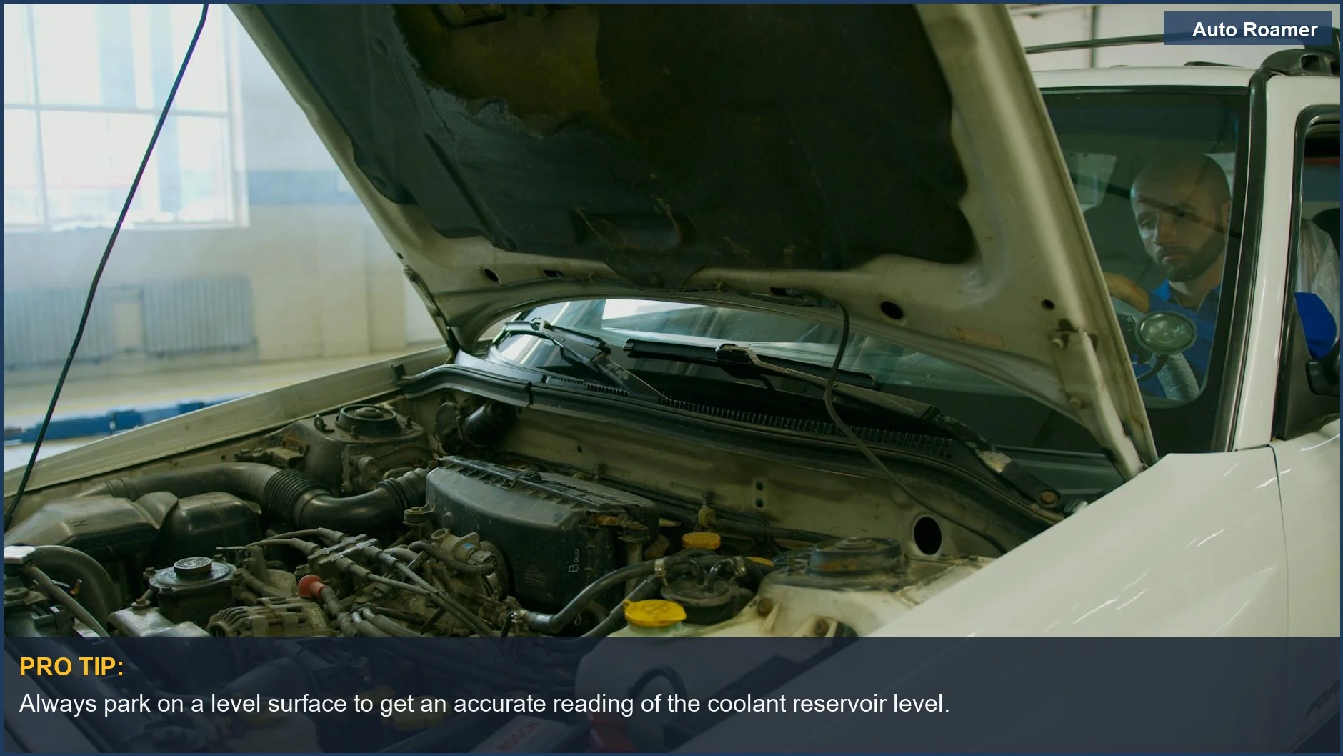 Person lifts car hood to check engine components, a key step in how to check and top off coolant.