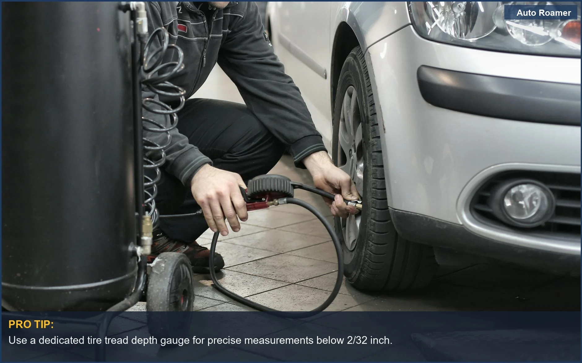 Mechanic uses a tire tread depth gauge to accurately measure tire wear in an auto repair shop.