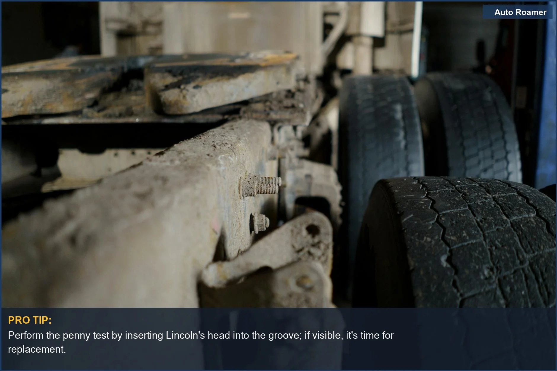 Penny inserted head-down into a truck tire groove, demonstrating the penny test for checking tire tread depth.