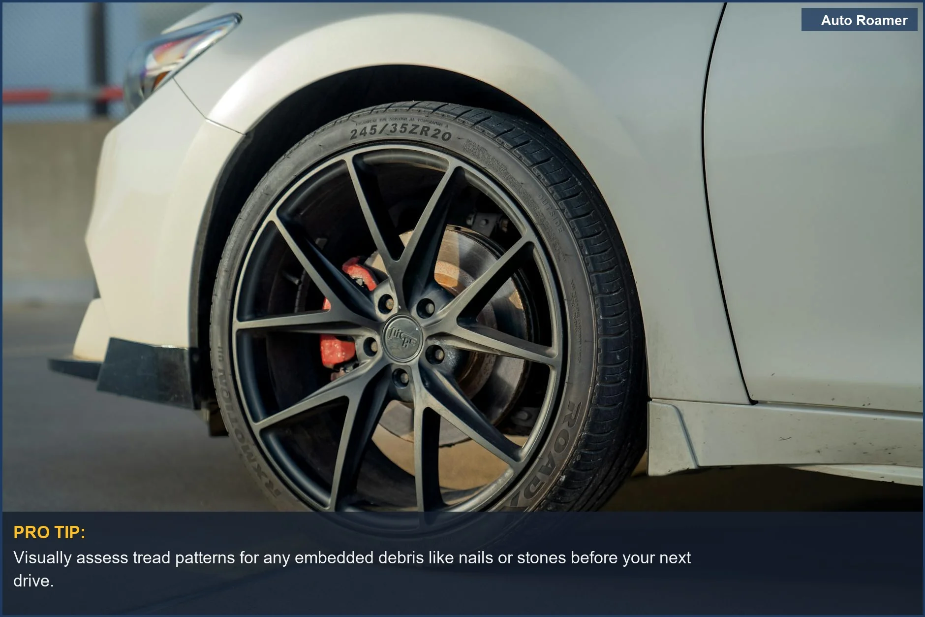 Urban street view of a car wheel and tire, showcasing tread design and urban driving conditions.
