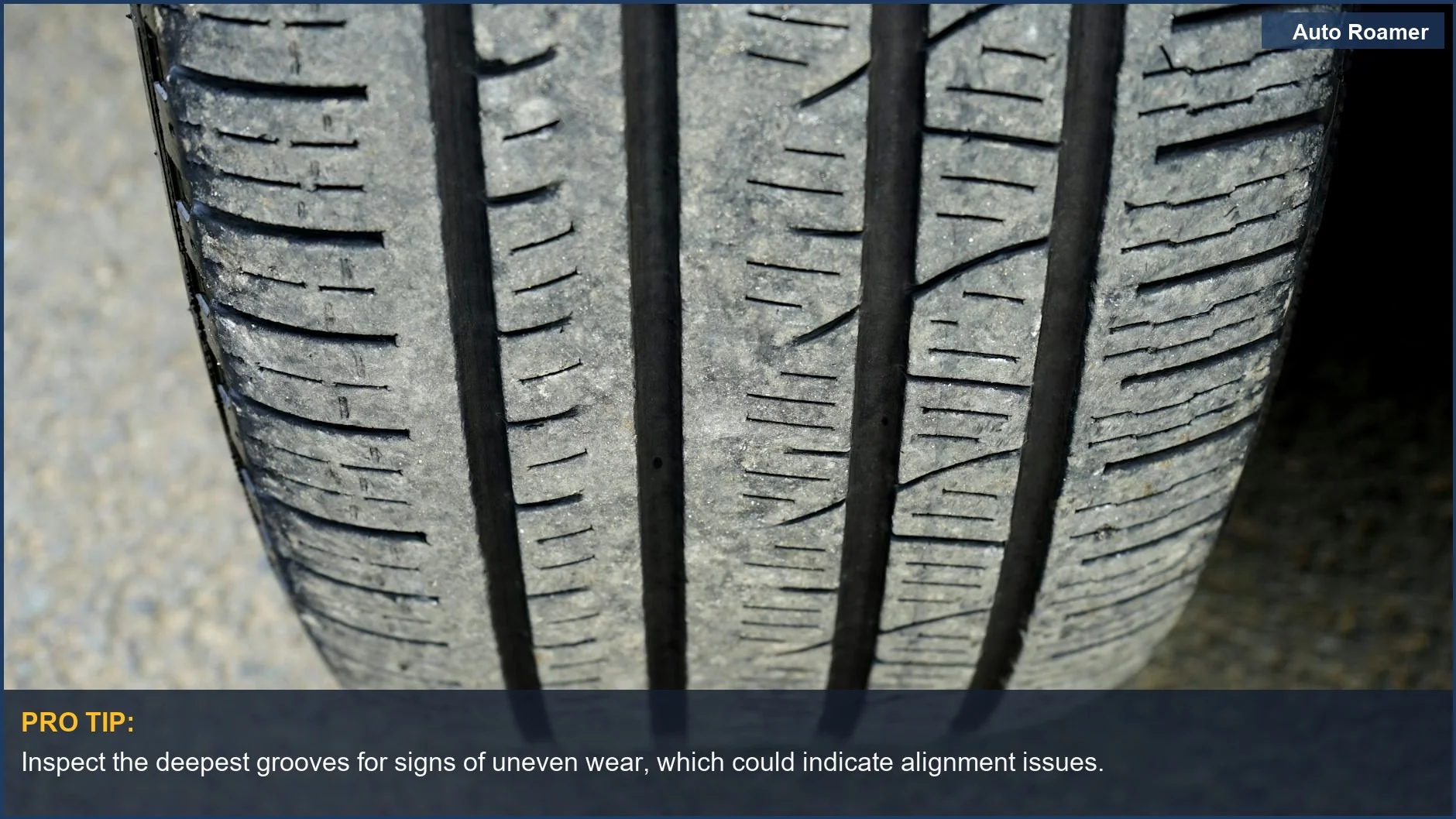 Close-up of worn car tire tread, highlighting the need to check tire tread depth for safety.