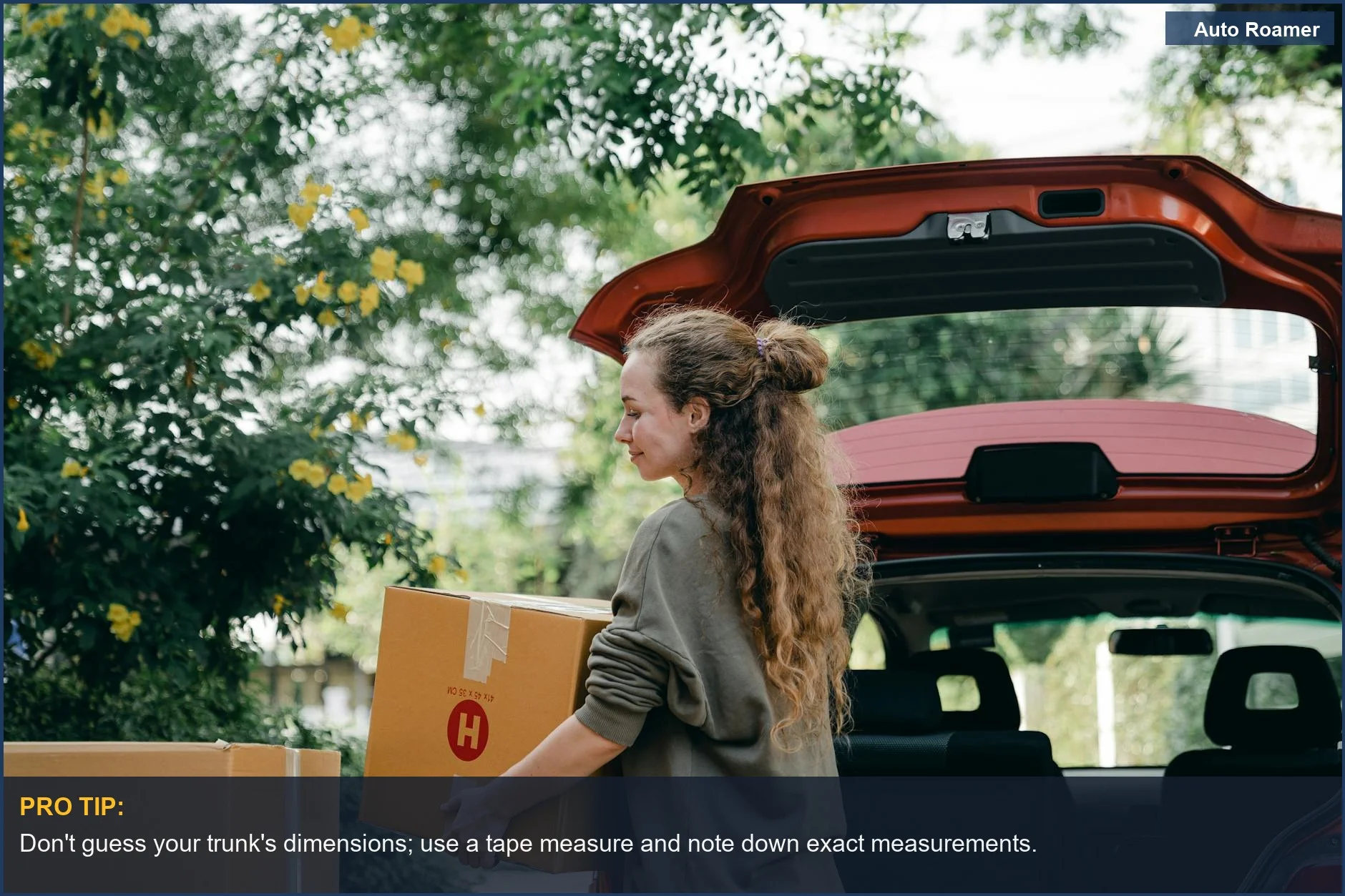Young woman taking boxes from car trunk during a move, emphasizing choosing trunk organizer based on need.