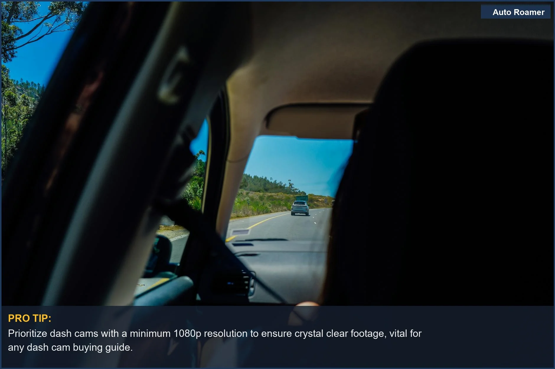 Scenic landscape viewed from inside a car, illustrating a pleasant drive on a camping trip.