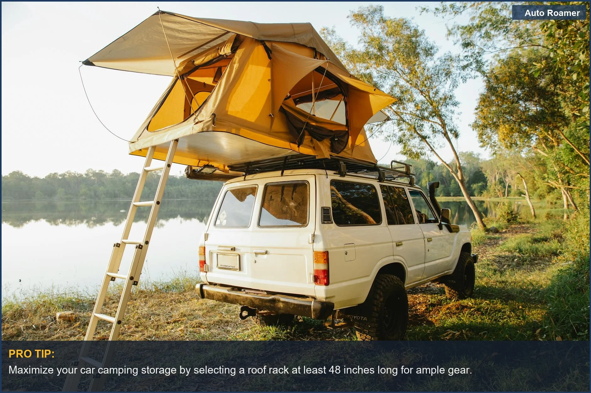 Overland car with roof rack loaded for car camping storage, parked by a scenic lake.