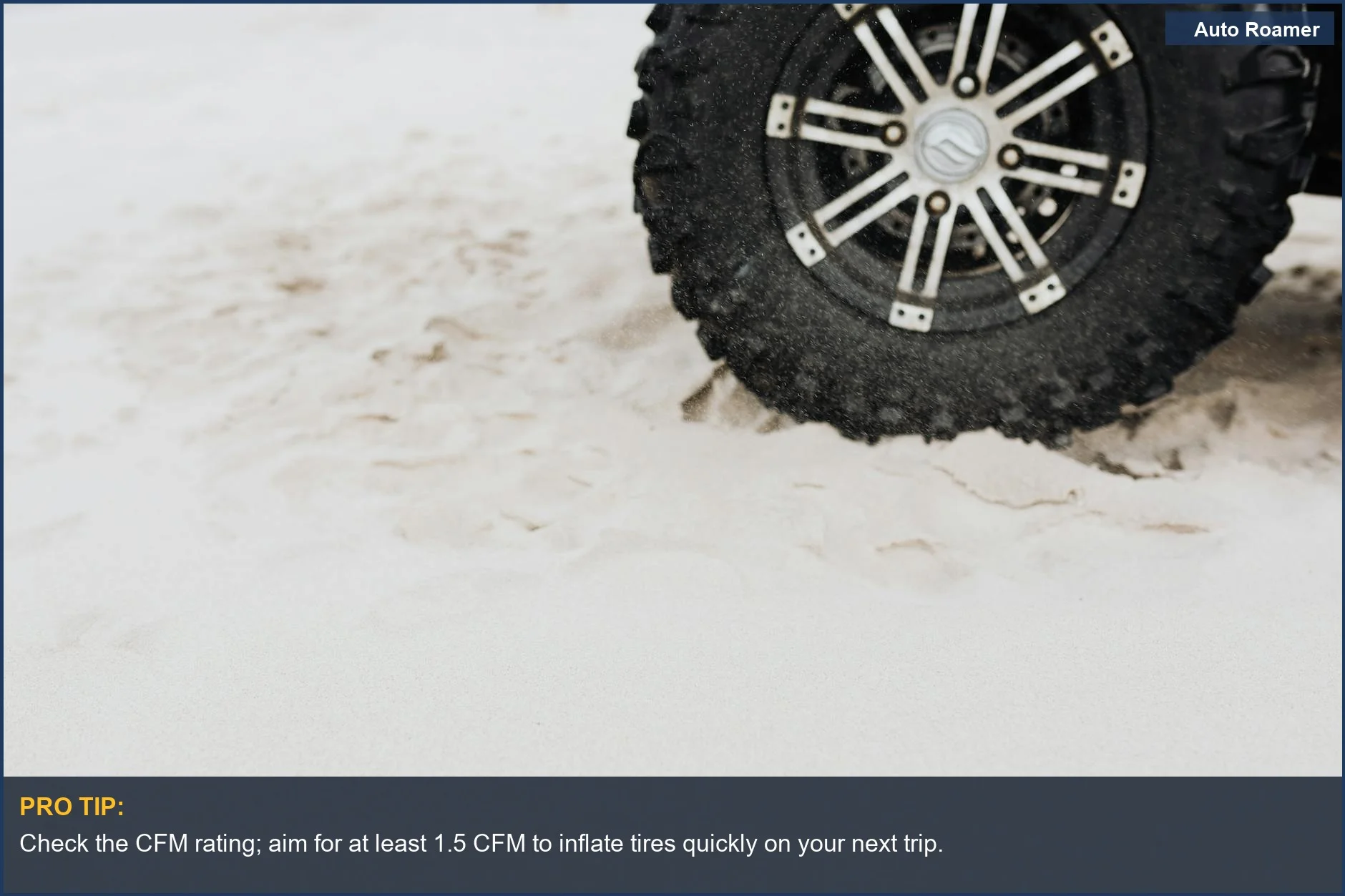 Rugged off-road tire on sandy beach, ideal for car camping adventures and portable air compressors.