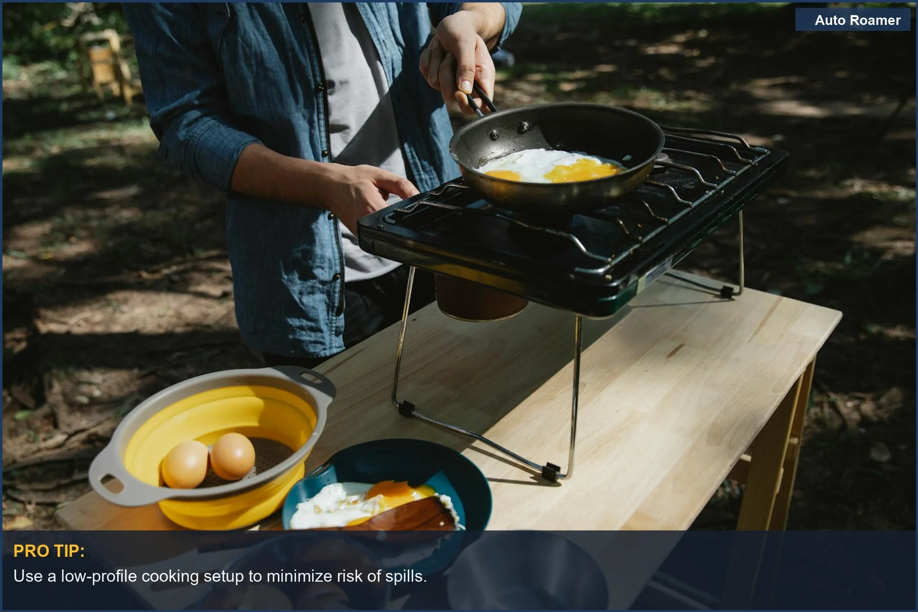 Anonymous male frying eggs on a skillet using a metal stove in a forest.