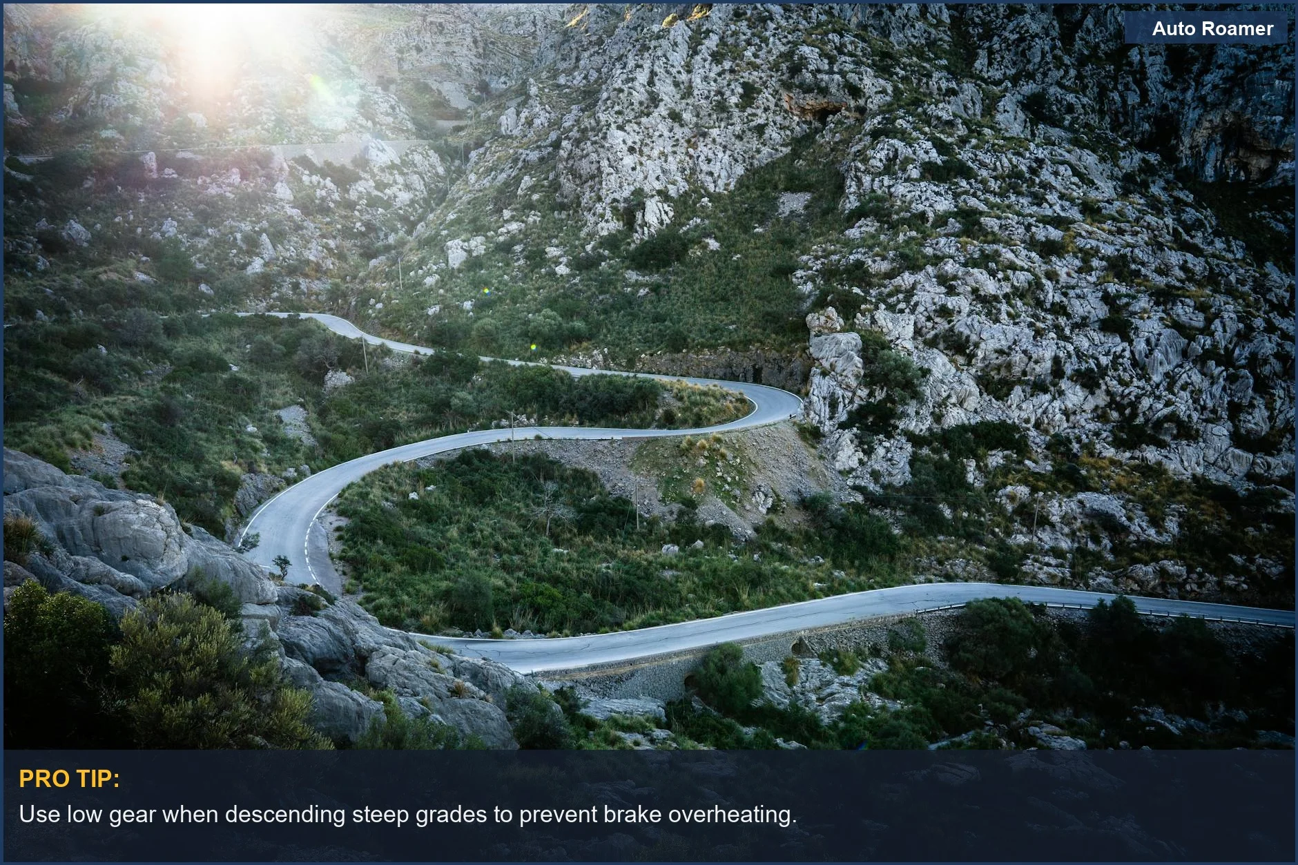 Scenic view of a winding road through rocky mountains at sunrise for safe travel