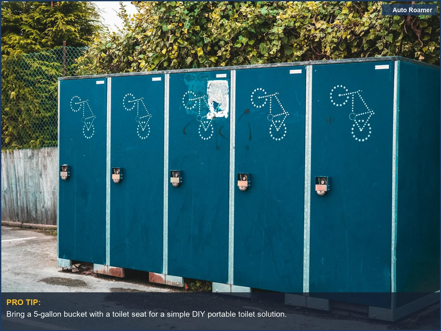 Blue portable toilet containers lined up against greenery in a camping area.