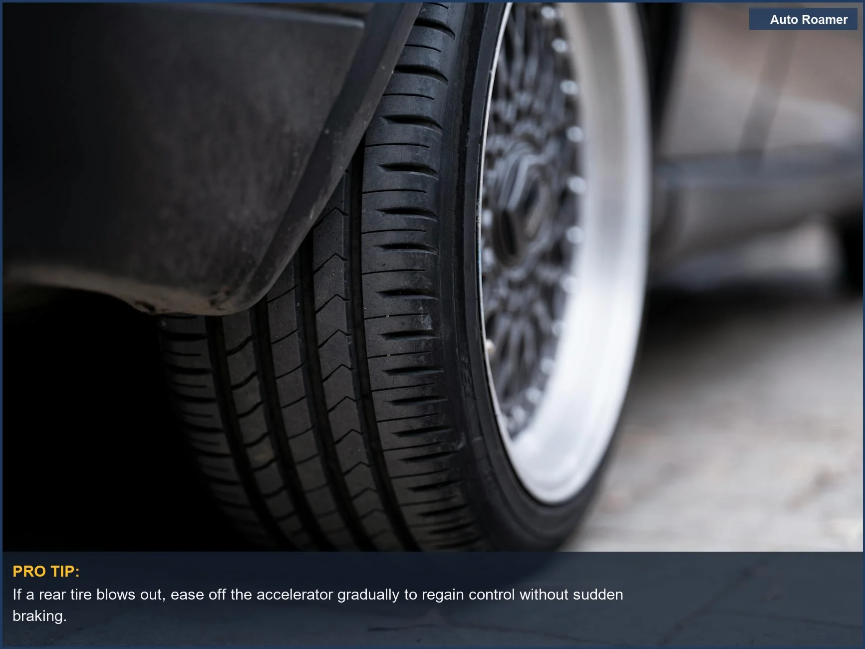 Detailed view of a car tire on urban pavement, showing tread and wheel design.