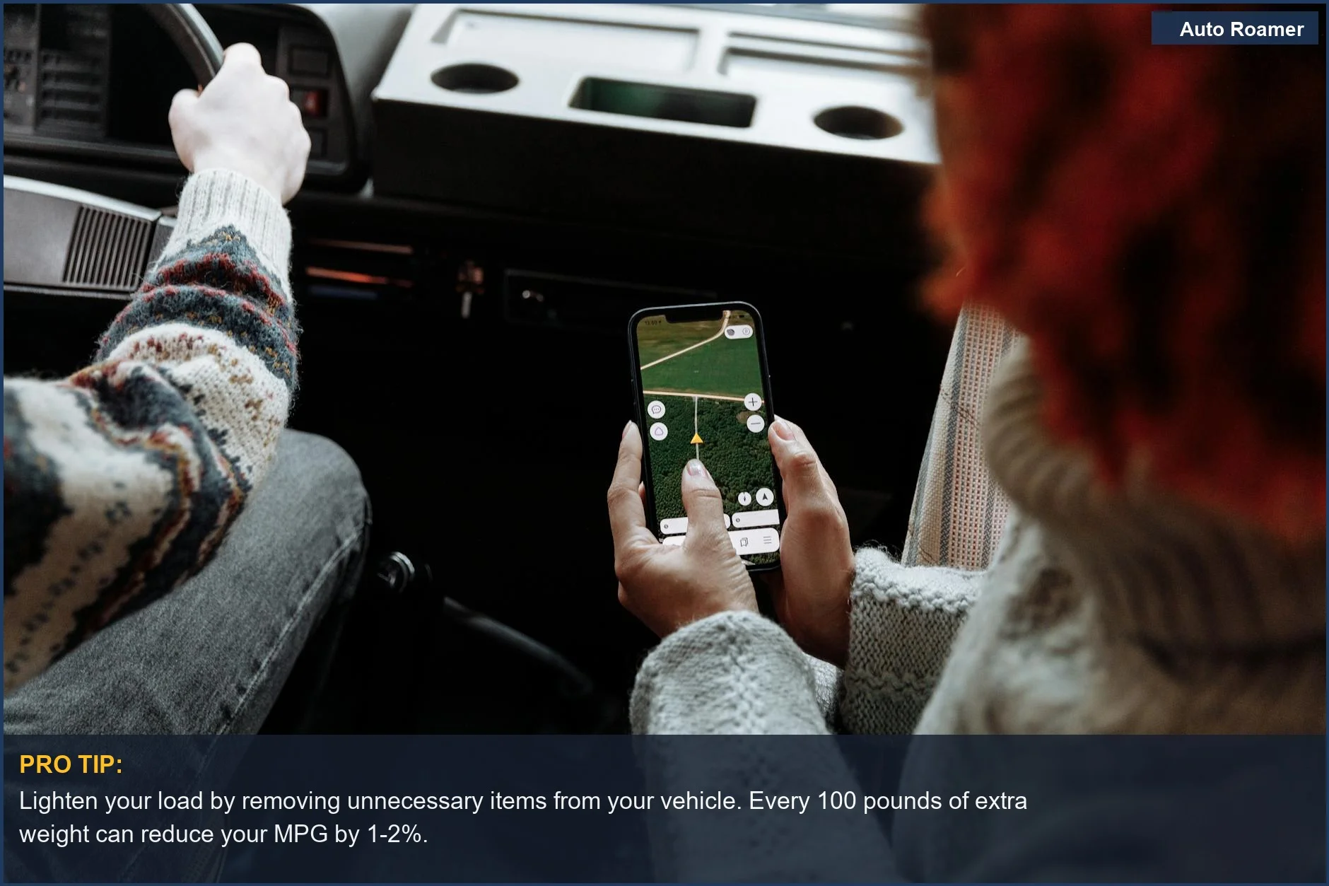 Two travelers using a navigation app on a smartphone inside a car, planning their route to maximize mpg on a road journey.