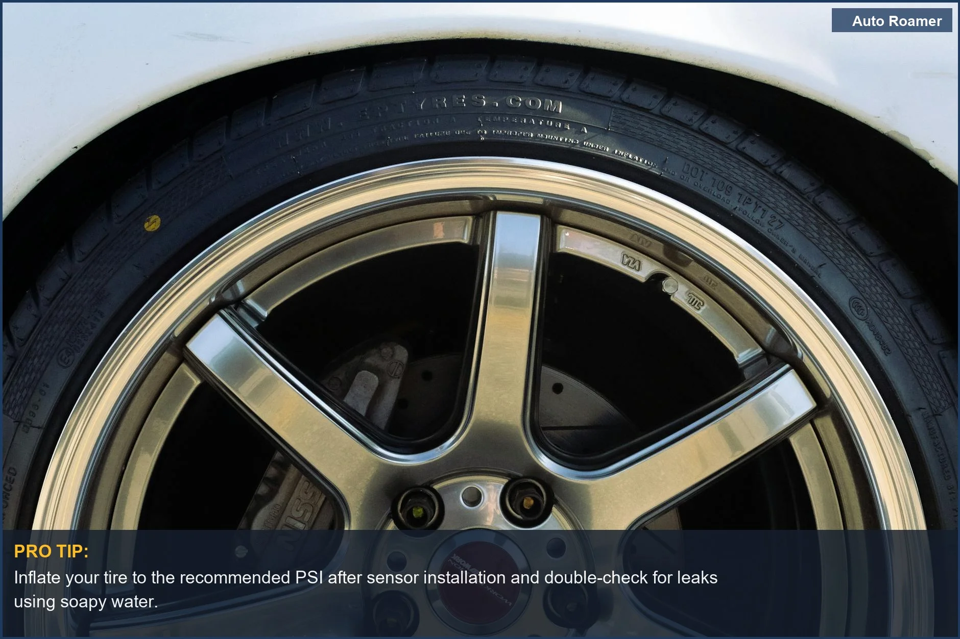 Detailed view of a modified car's alloy wheel and tire, showing the TPMS installation process.