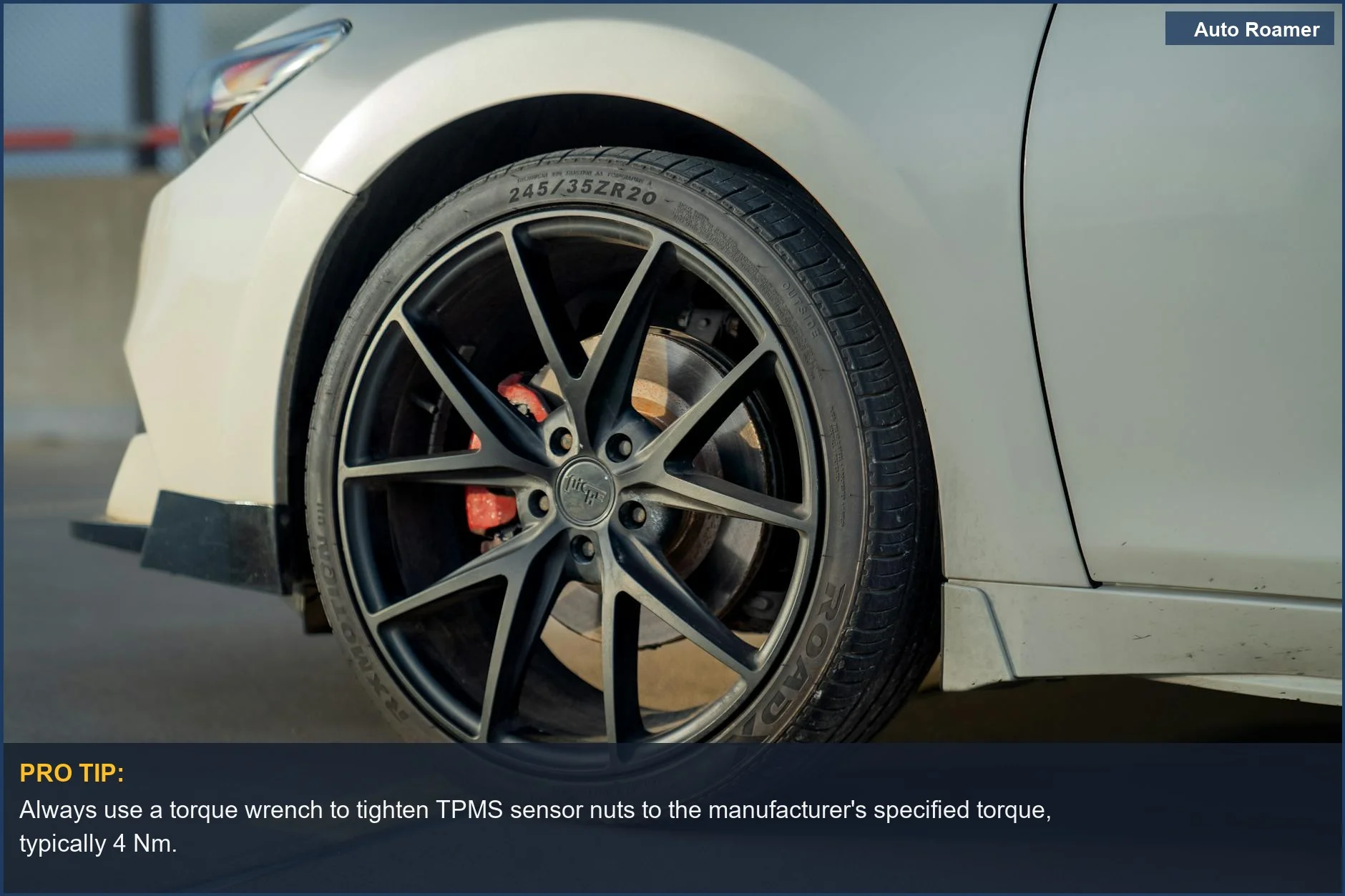 Urban street view of a car's tire and wheel, emphasizing the importance of a DIY TPMS setup.