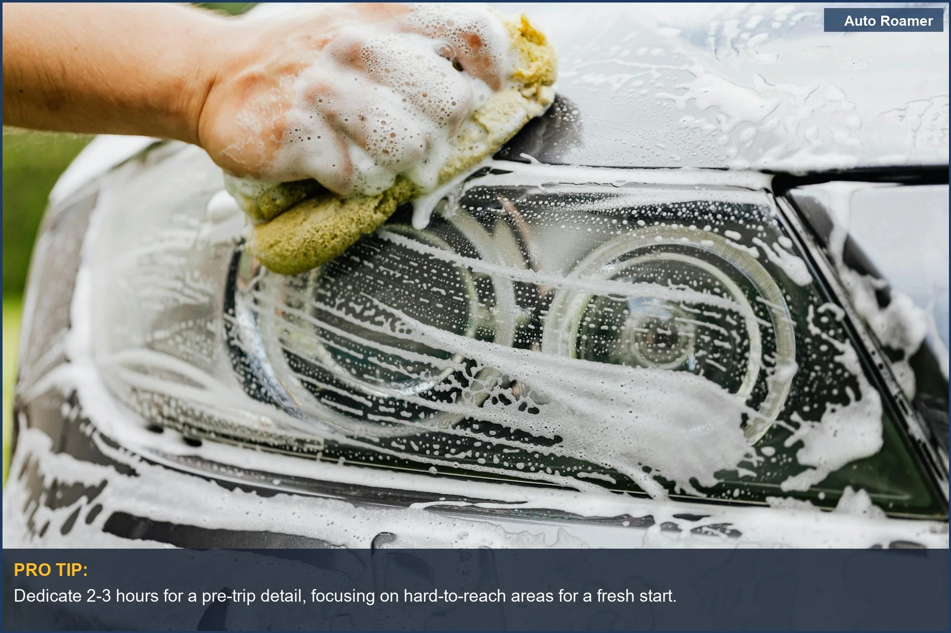 Detailing a car headlight with a sponge and suds, essential for maintaining a clean car for road trips.