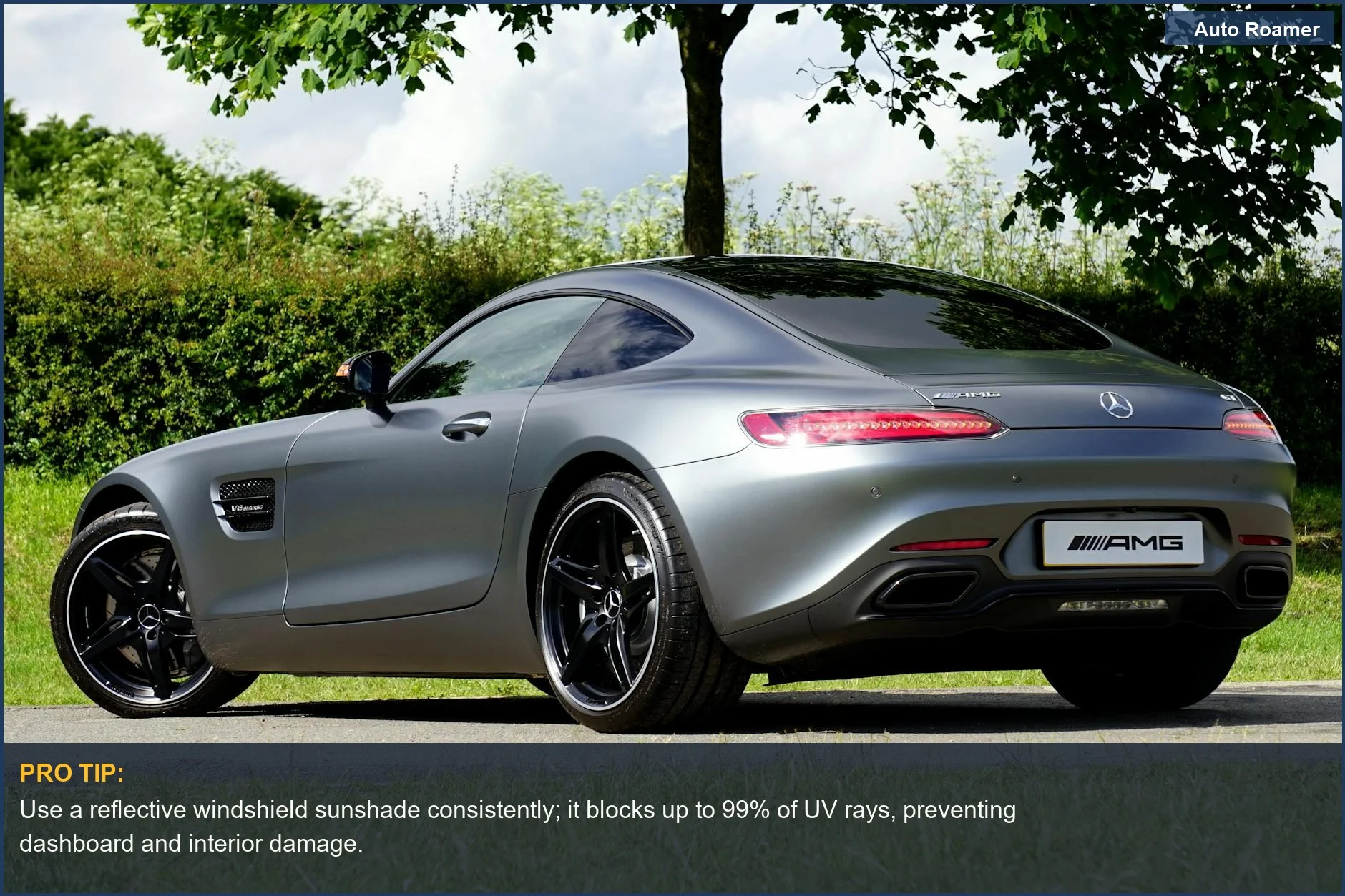A sleek silver Mercedes AMG GT parked outdoors by trees on a sunny day, illustrating how to prevent car from heating up in summer.