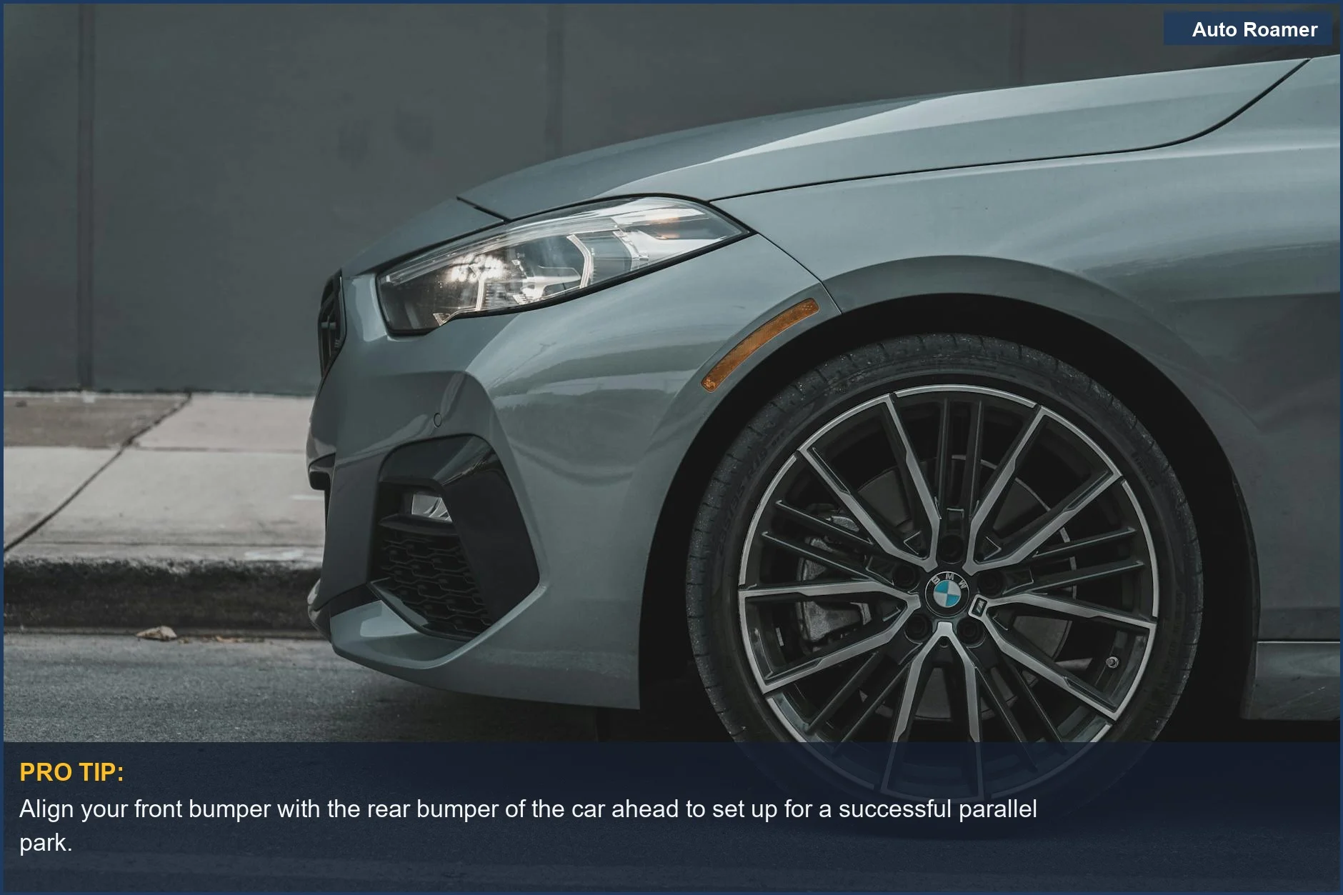 Detailed view of a grey luxury car's front fender and wheel, crucial for understanding parallel parking proximity to the curb.