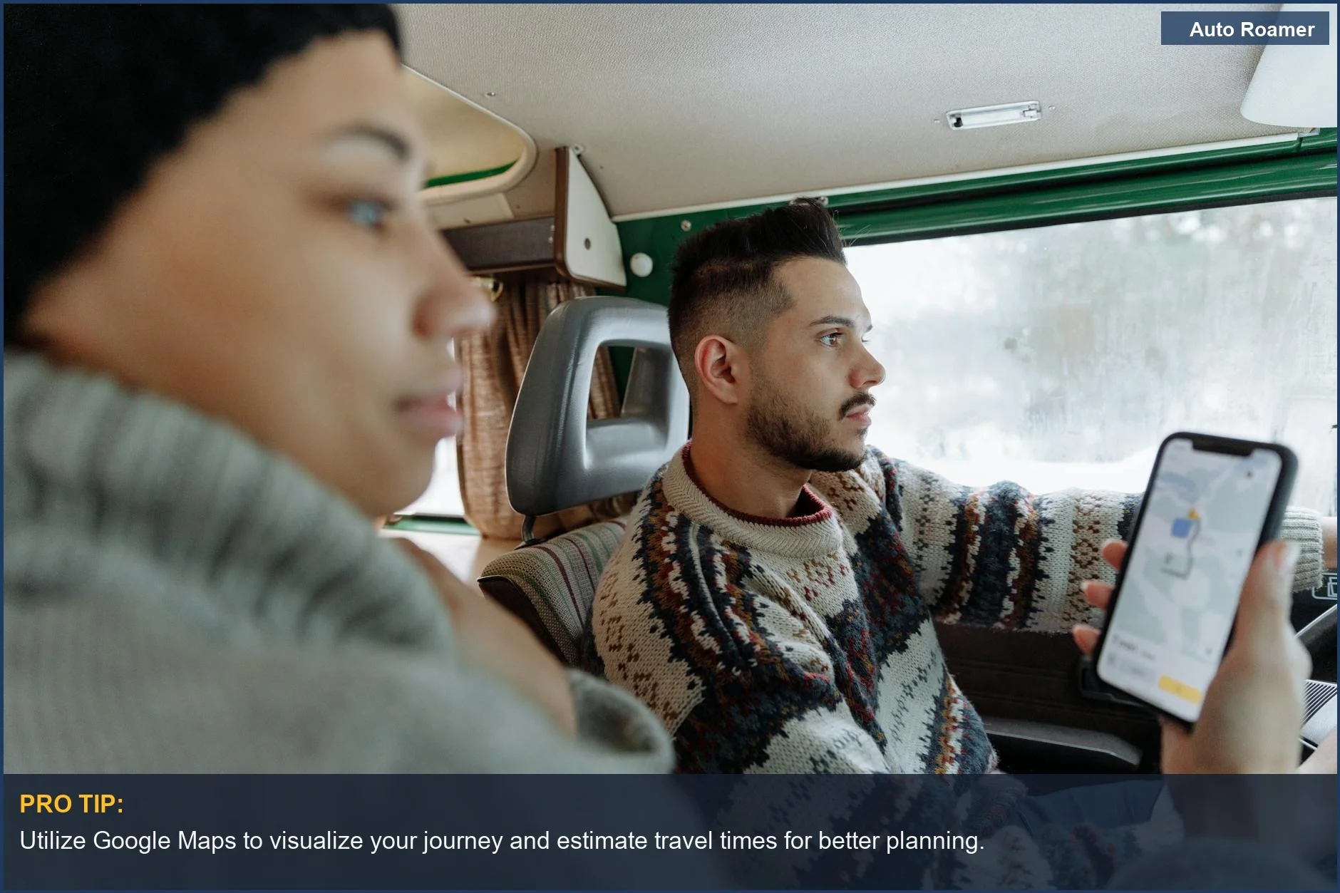 Couple using a navigation app inside a vintage campervan during their cross-country road trip planning.