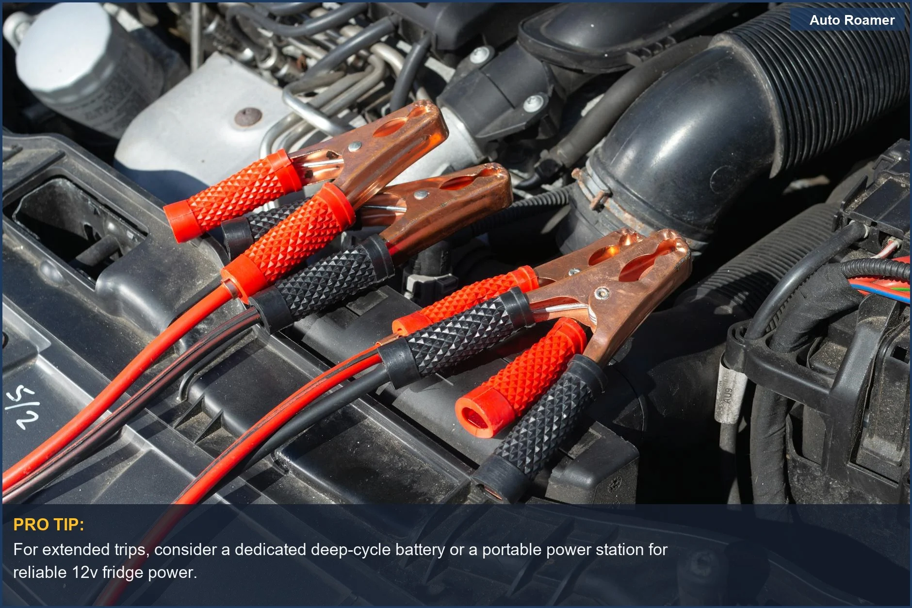 Car engine bay with battery charger connected, highlighting car camping power solutions.