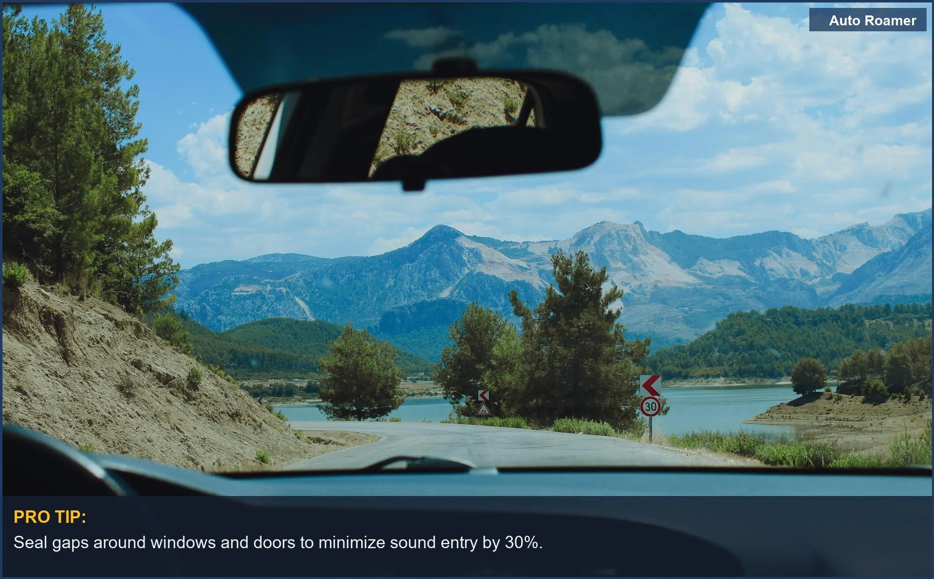 Interior view of a car showcasing a lush mountain backdrop while traveling on a scenic route to combat road noise.