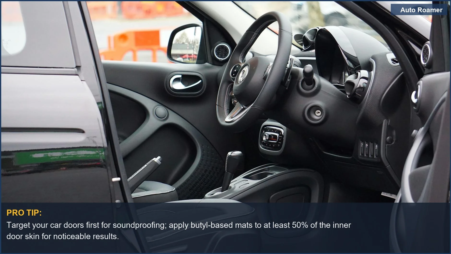 Sleek car interior showcasing the steering wheel and dashboard through an open door, highlighting soundproofing car opportunities.