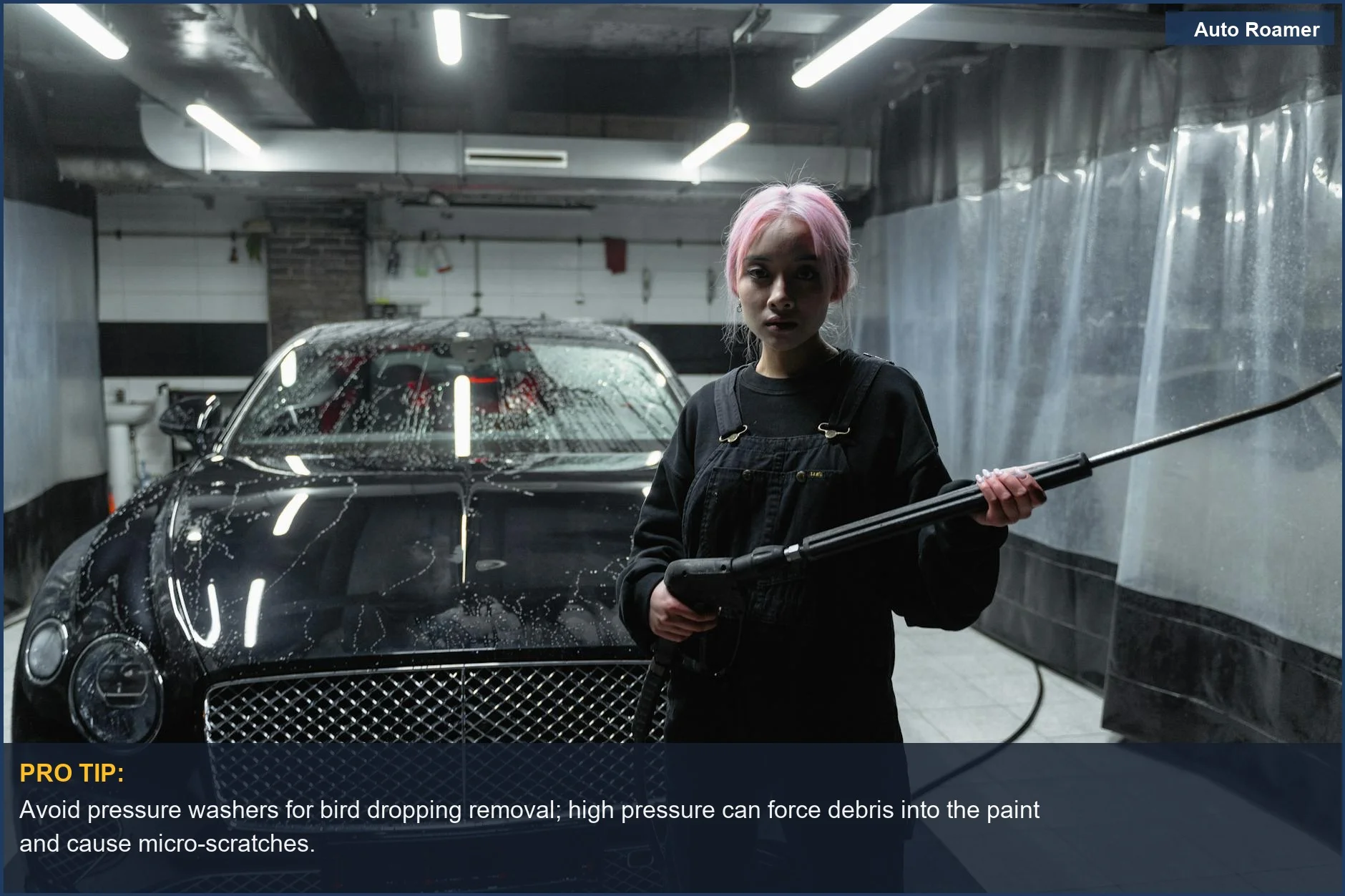 Detailer carefully cleaning a luxury black car with a spray bottle and microfiber, avoiding pressure washer risks.