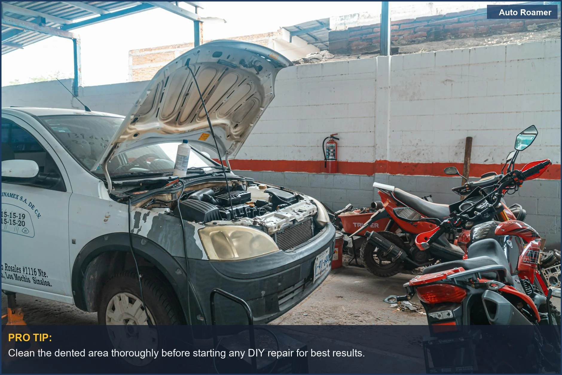 Car in a garage with tools, demonstrating paintless dent repair at home possibilities.