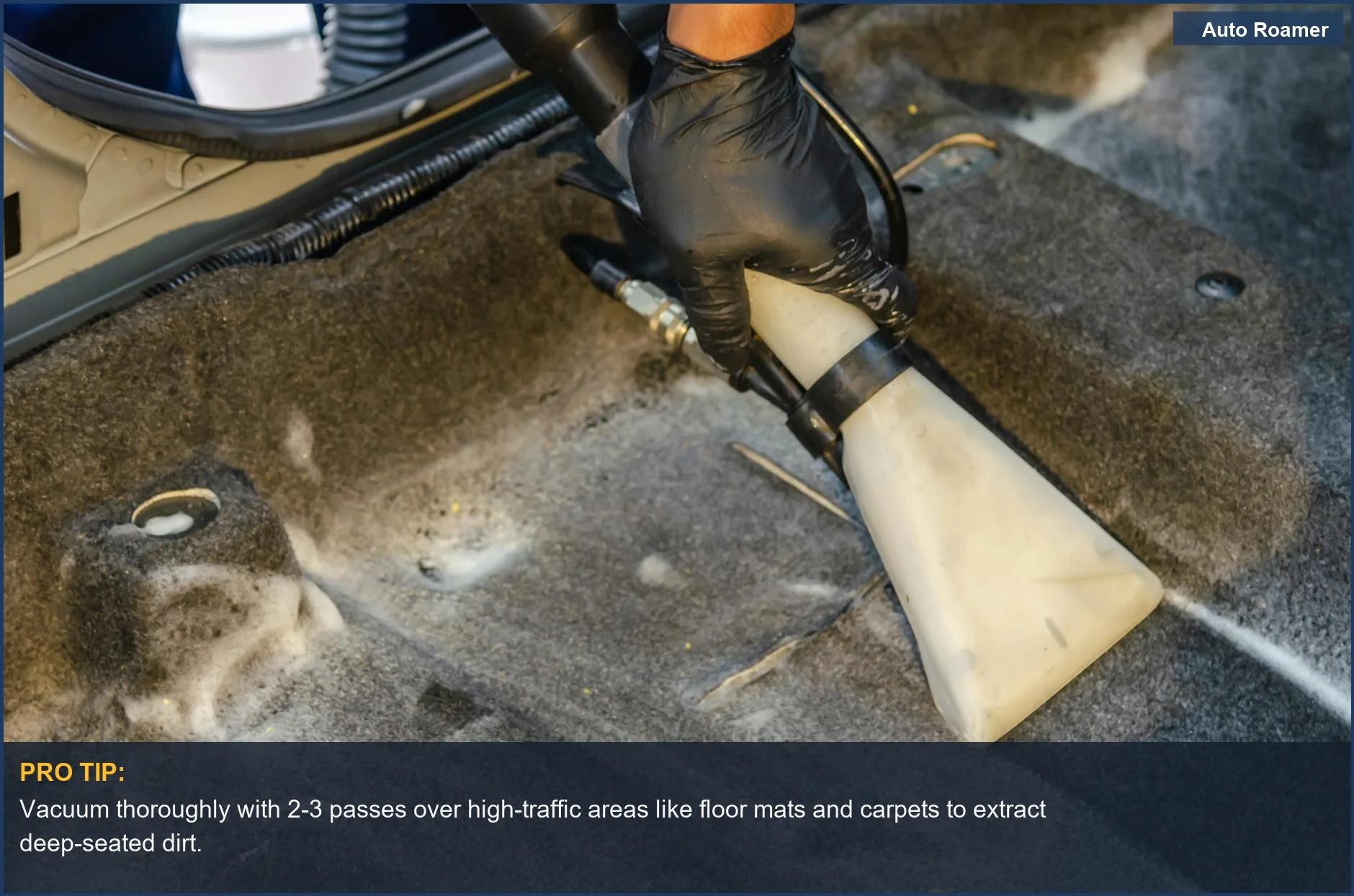 A gloved hand efficiently vacuums car floor carpets, showing how to get pet hair out of car upholstery.