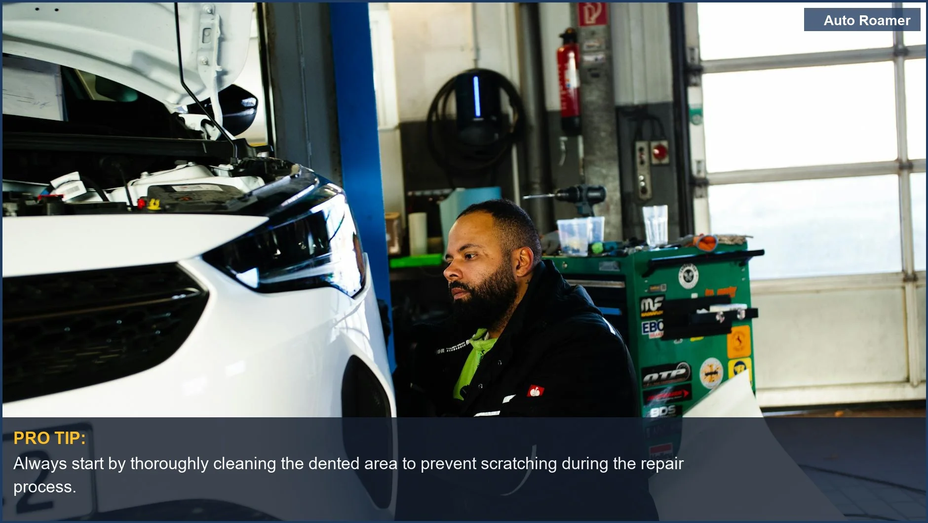 Mechanic inspecting a car's dented door panel, illustrating diy dent removal possibilities at home.