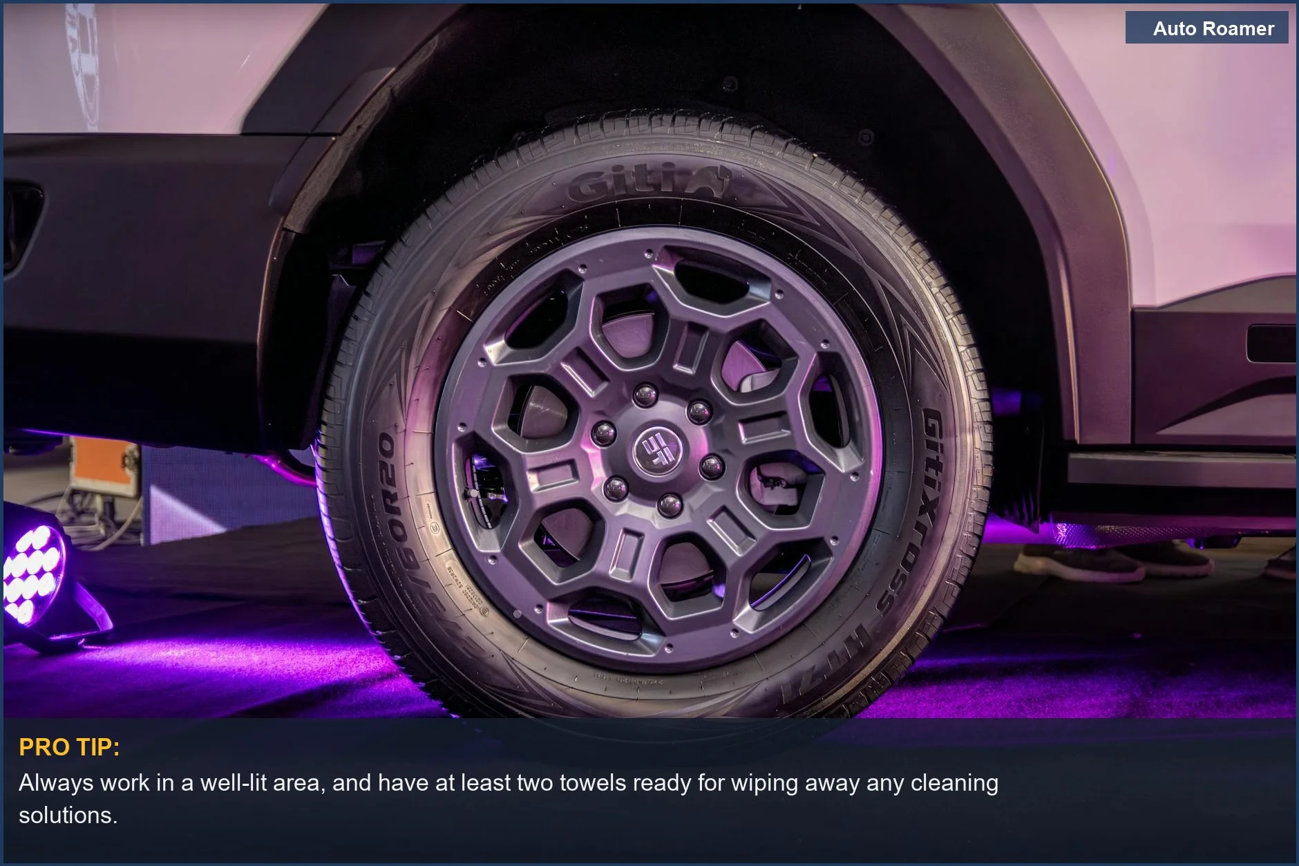 Detailed shot of a car's tire with purple lighting, hinting at the car's aesthetic.