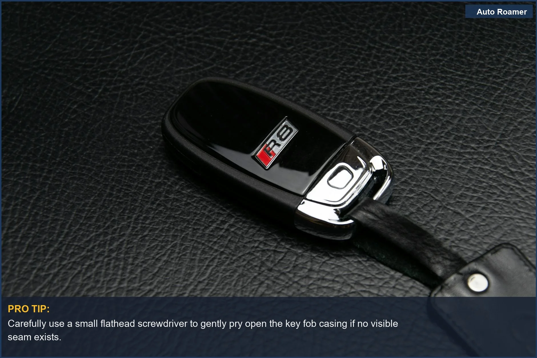 Close-up of a luxury car key fob on a textured leather surface