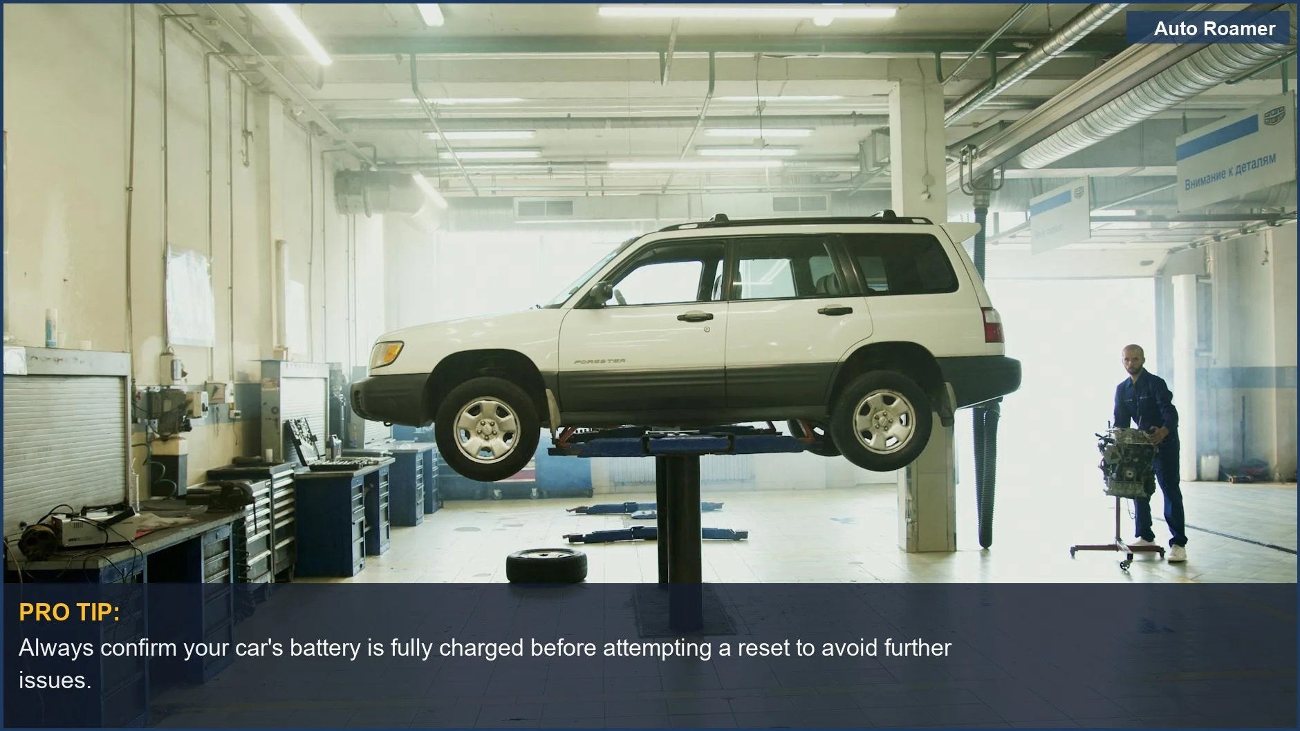Mechanic working on a car lifted in a modern garage, demonstrating car maintenance.