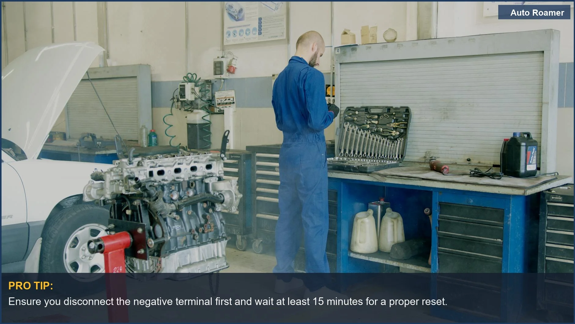 Close-up of a mechanic's hands disconnecting a car battery terminal for engine light reset.